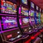 Colorful slot machines lined up in a casino with neon lights and jackpot displays.