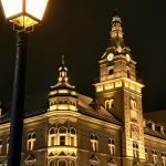 Stunning night view of a vintage building in Suceava, Romania, beautifully lit against the dark sky.