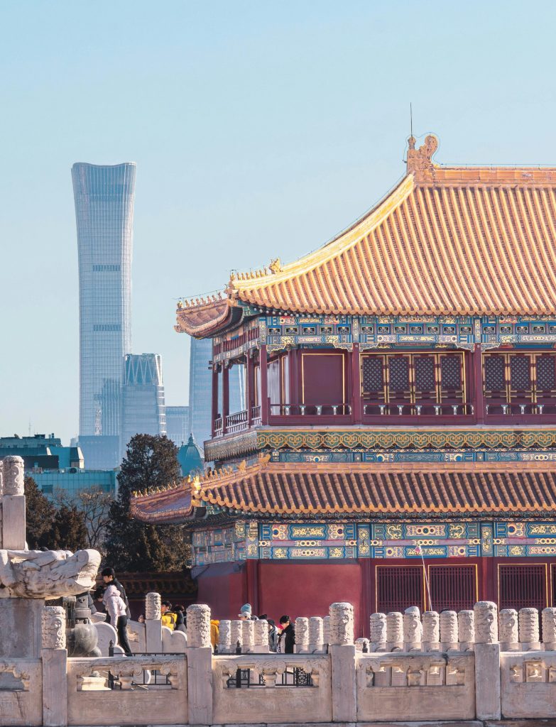 Traditional Chinese temple with Beijing skyline, featuring iconic modern skyscraper in daytime.