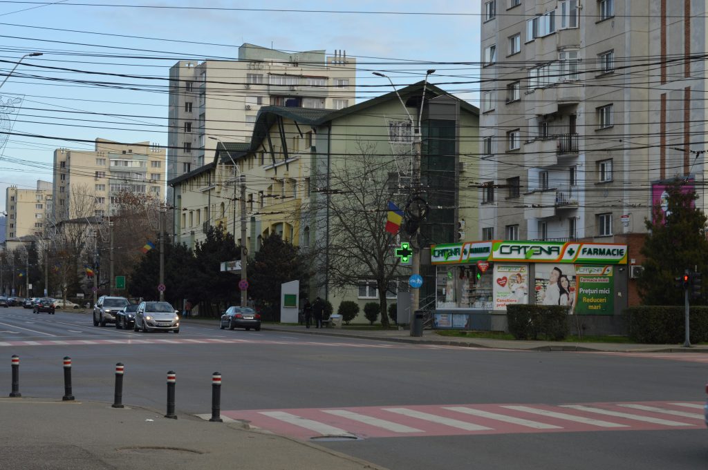 Urban street view in Romania featuring pharmacy Catena and surrounding buildings.
