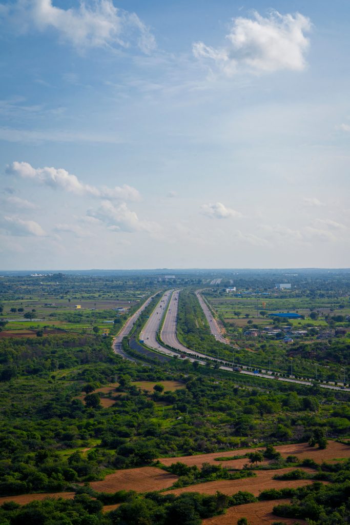 Stunning aerial view of a highway cutting through the lush countryside near Hyderabad, India.